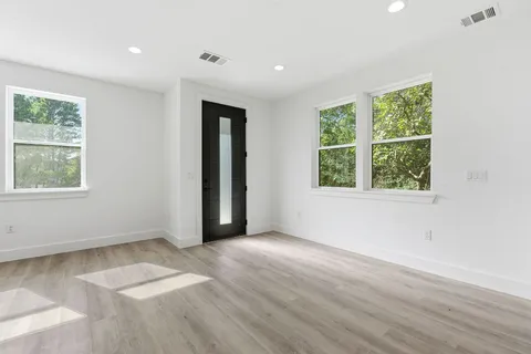 a large kitchen with cabinets wooden floor and a stainless steel appliances