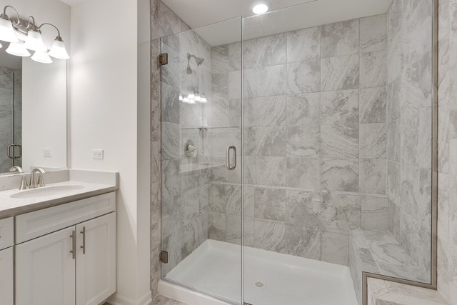 1990 Stuttle Road Batavia, IL 60510 - Photo 18 of 25 a bathroom with a shower a sink and a mirror