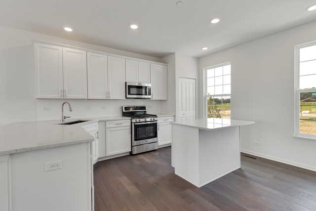 1990 Stuttle Road Batavia, IL 60510 - Photo 6 of 25 a kitchen with white cabinets and appliances