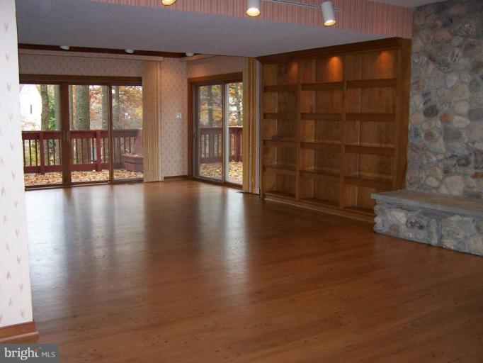10 Redgate Court Silver Spring, MD 20905 - Photo 24 of 30 an empty room with wooden floor and windows