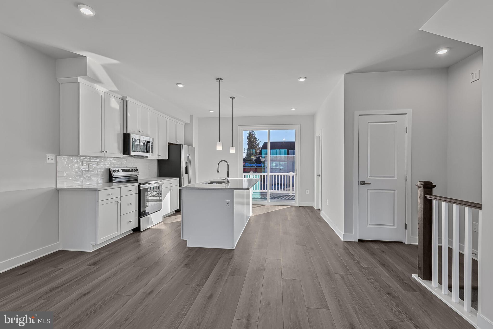 9 Oasis Avenue Ranson, WV 25438 - Photo 13 of 39 a kitchen with white cabinets and stainless steel appliances
