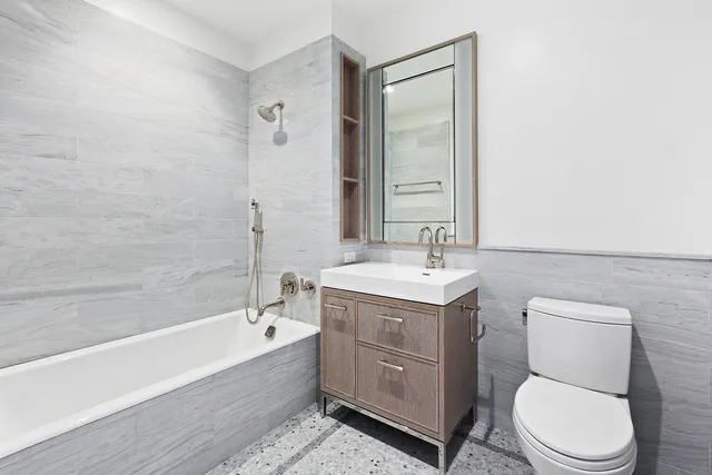 a bedroom with furniture and a large window