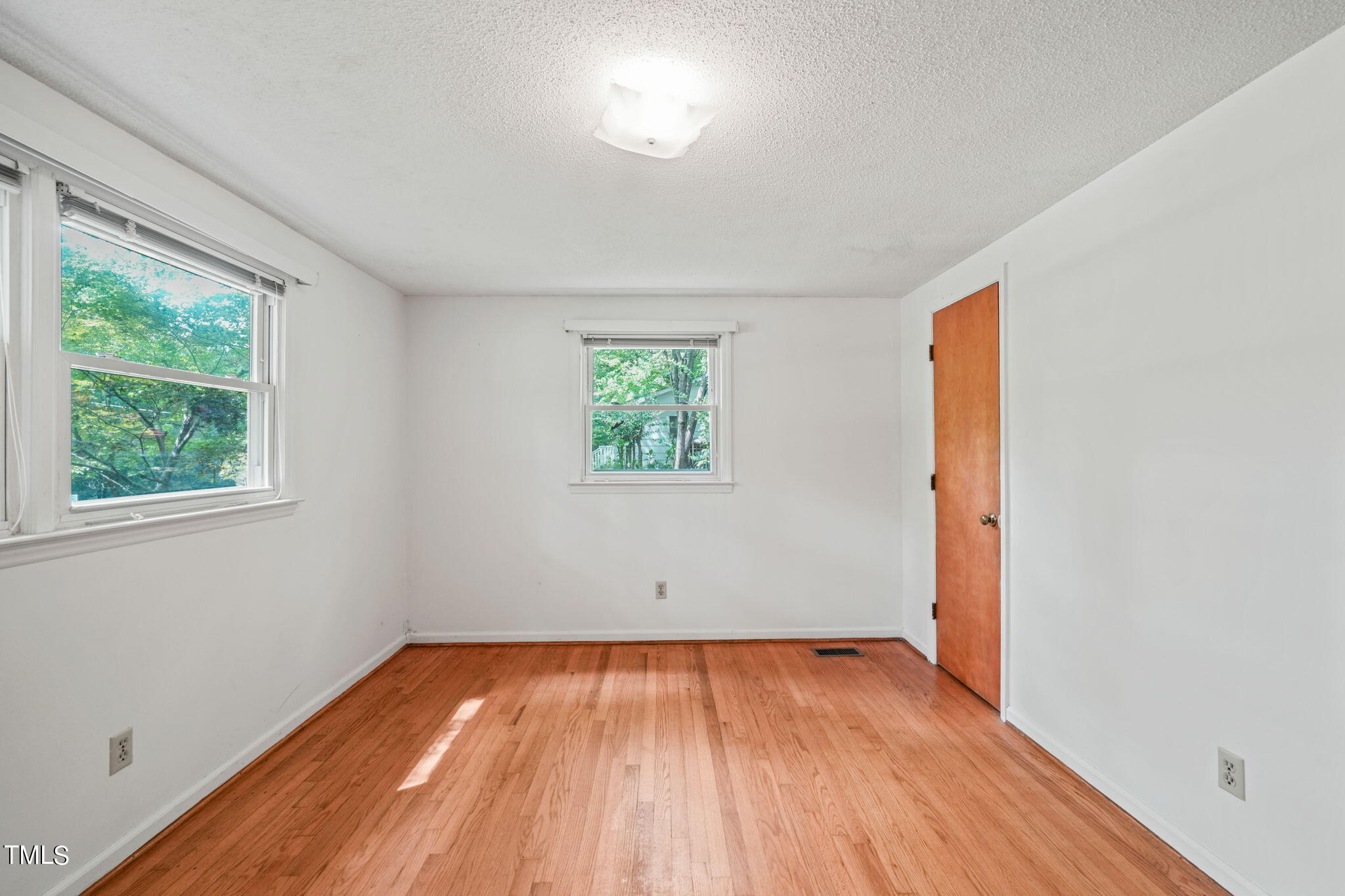 3015 Old Raleigh Road Apex, NC 27502 - Photo 21 of 47 an empty room with wooden floor and windows