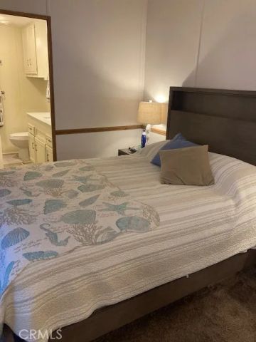 a bedroom with a bed and a night stand