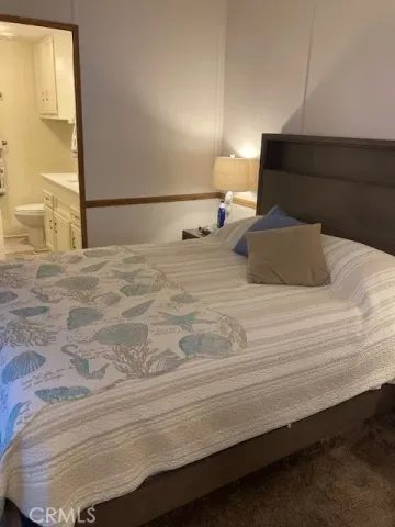 a bedroom with a bed and a night stand