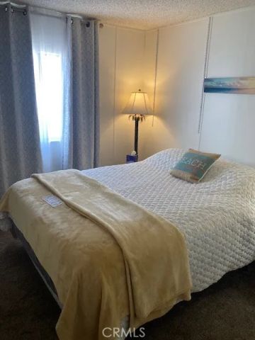 a bedroom with a bed and a lamp