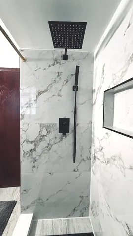 a bathroom with a toilet and mirror