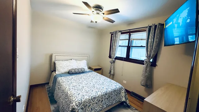 a bedroom with a bed and a tv