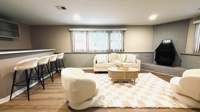 a living room with furniture and a mirror