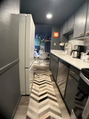 a kitchen with sink and refrigerator