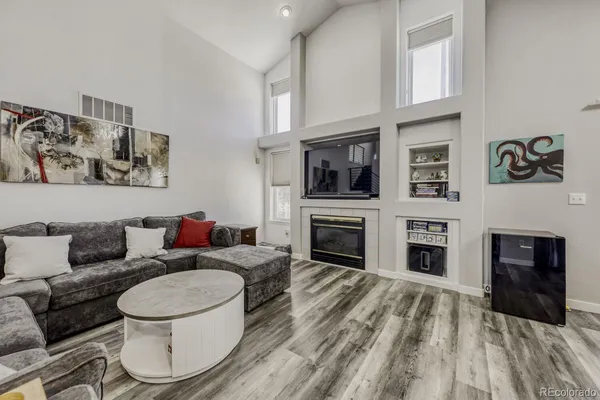 a living room with furniture a fireplace and cabinets