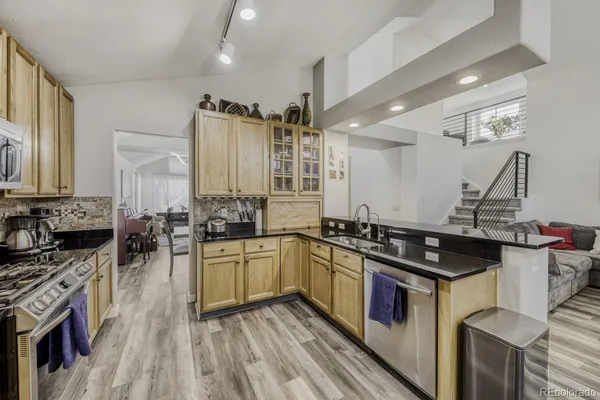 a kitchen with a stove sink and cabinets