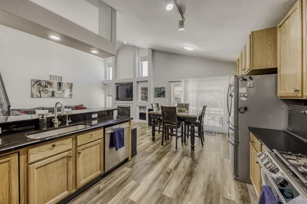 a kitchen with lots of counter top space and stainless steel appliances