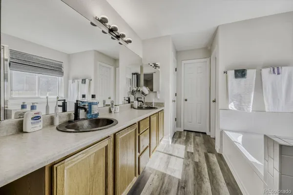 a kitchen with sink and refrigerator