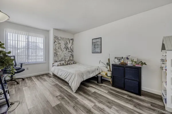 a bedroom with a bed dresser and a window