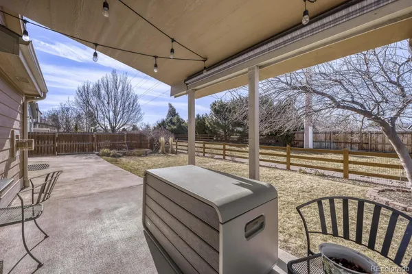 a view of a porch with furniture and a yard