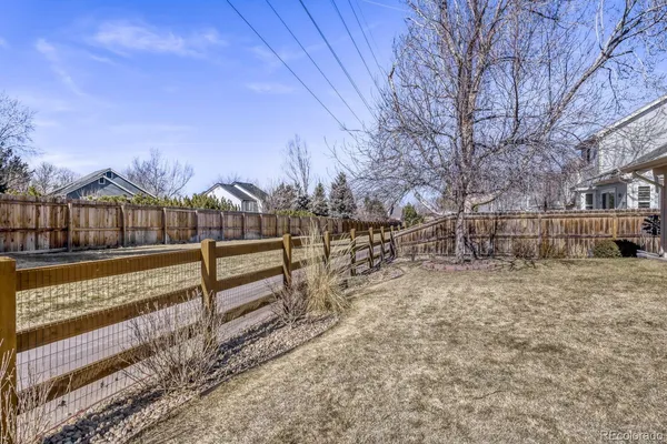 a view of street with wooden fence