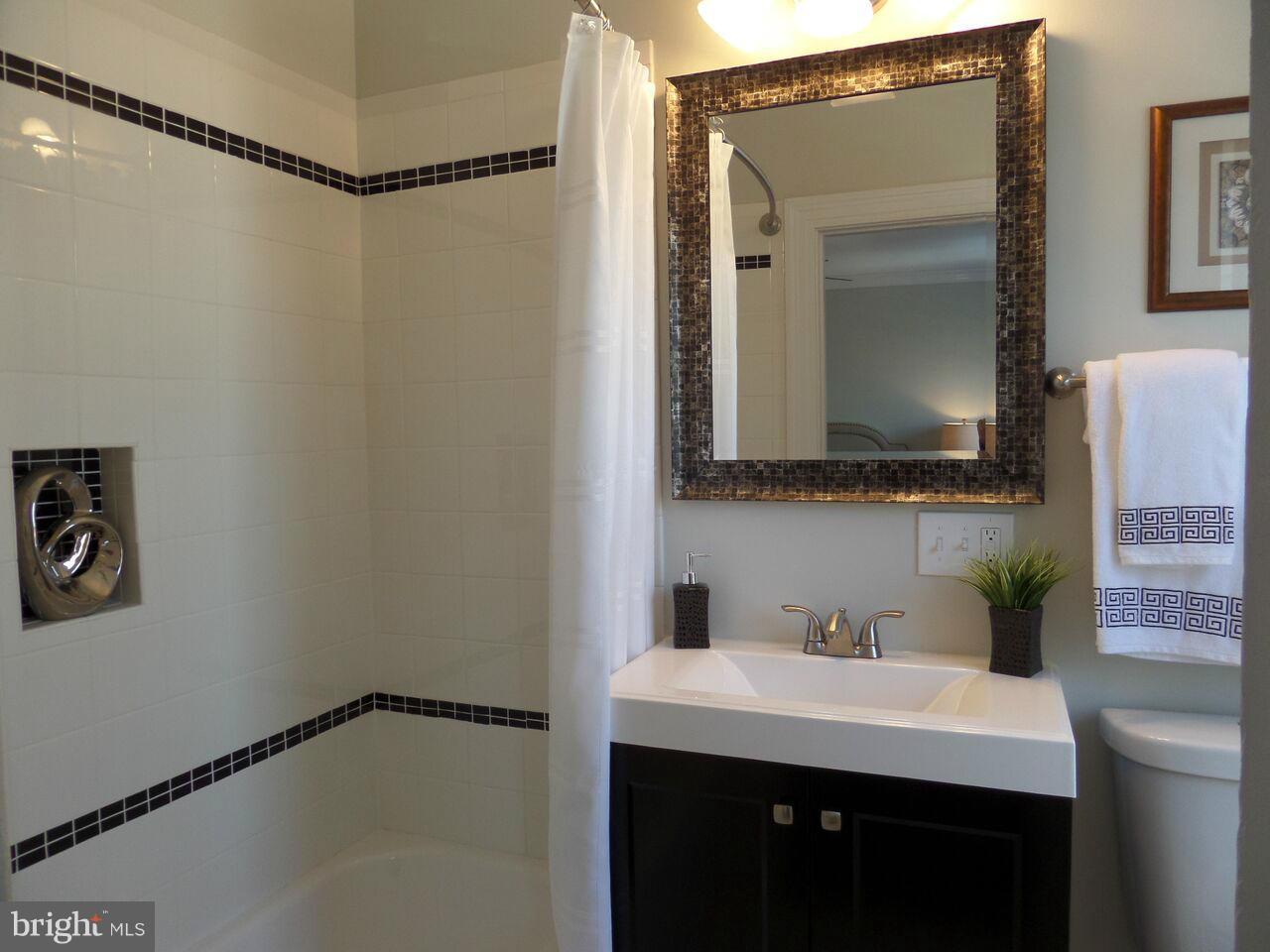 1326 Rittenhouse Street Northwest Washington, DC 20011 - Photo 14 of 28 a bathroom with a sink and a mirror