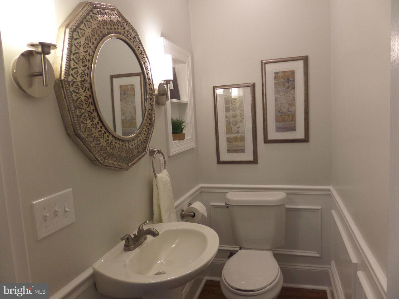 1326 Rittenhouse Street Northwest Washington, DC 20011 - Photo 22 of 28 a bathroom with a toilet mirror and sink