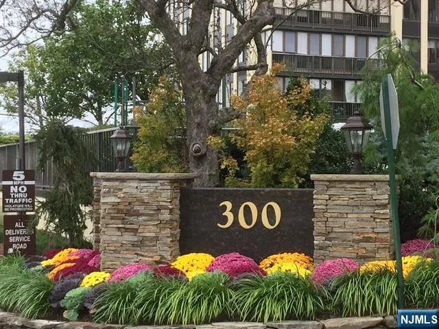 a street sign that is sitting in front of flowers