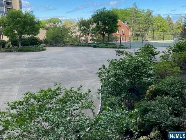 a view of a street with a houses in the background