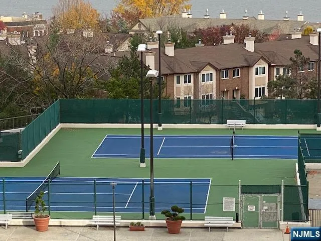 a view of a tennis ground with houses