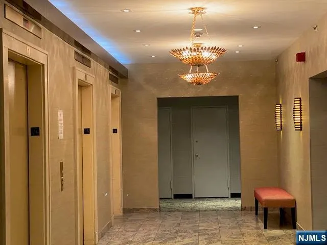 a view of a hallway with chandelier