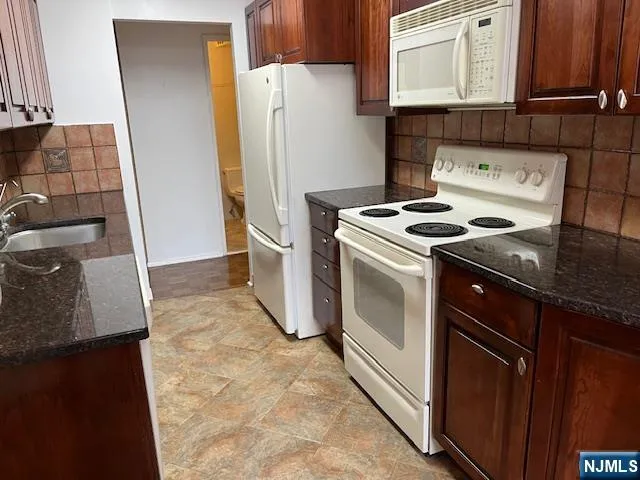 a kitchen with a stove sink and refrigerator