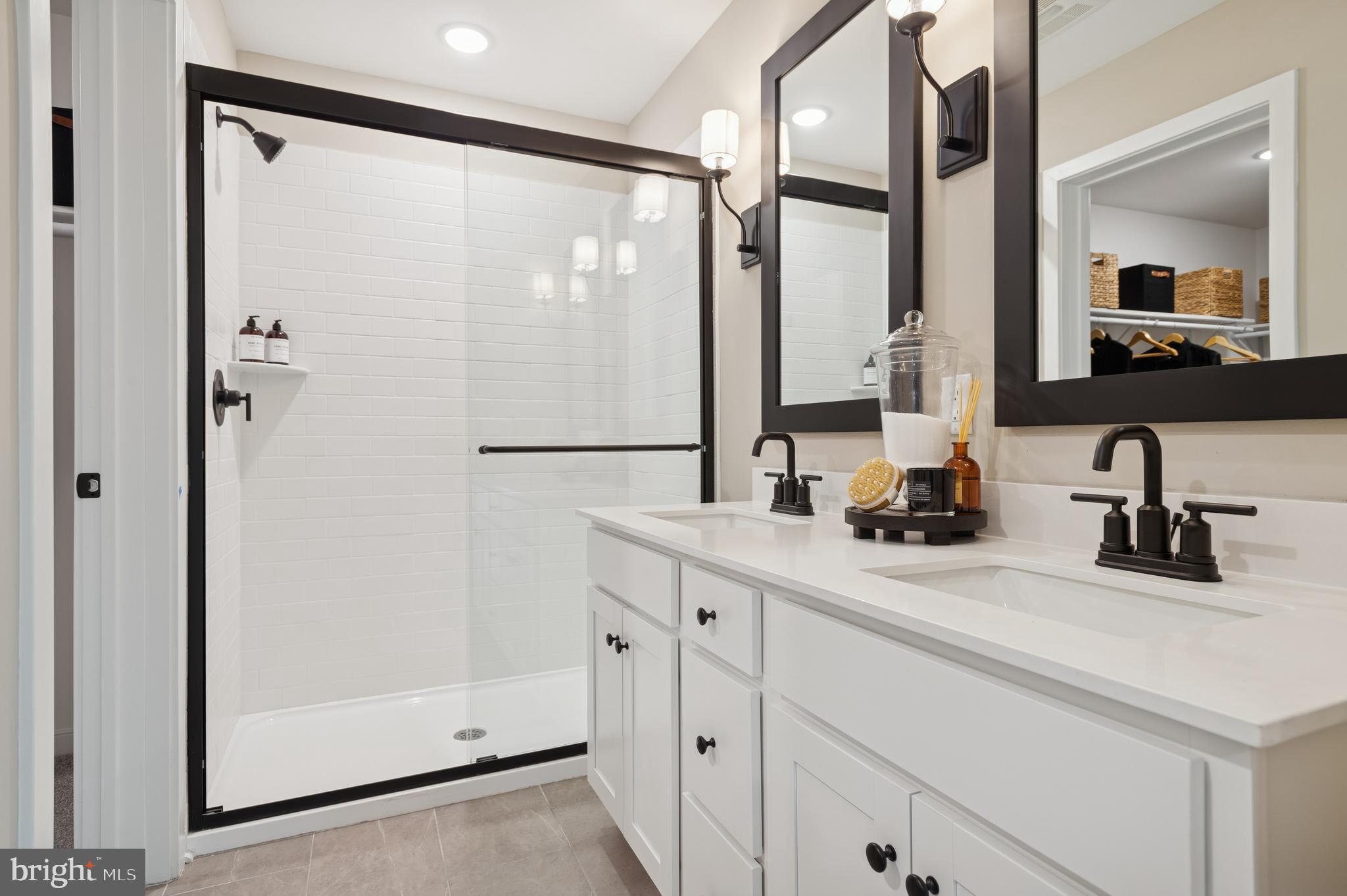 23 Butternut Drive, Unit 12 Berlin, NJ 08009 - Photo 13 of 38 a bathroom with a double vanity sink and mirror