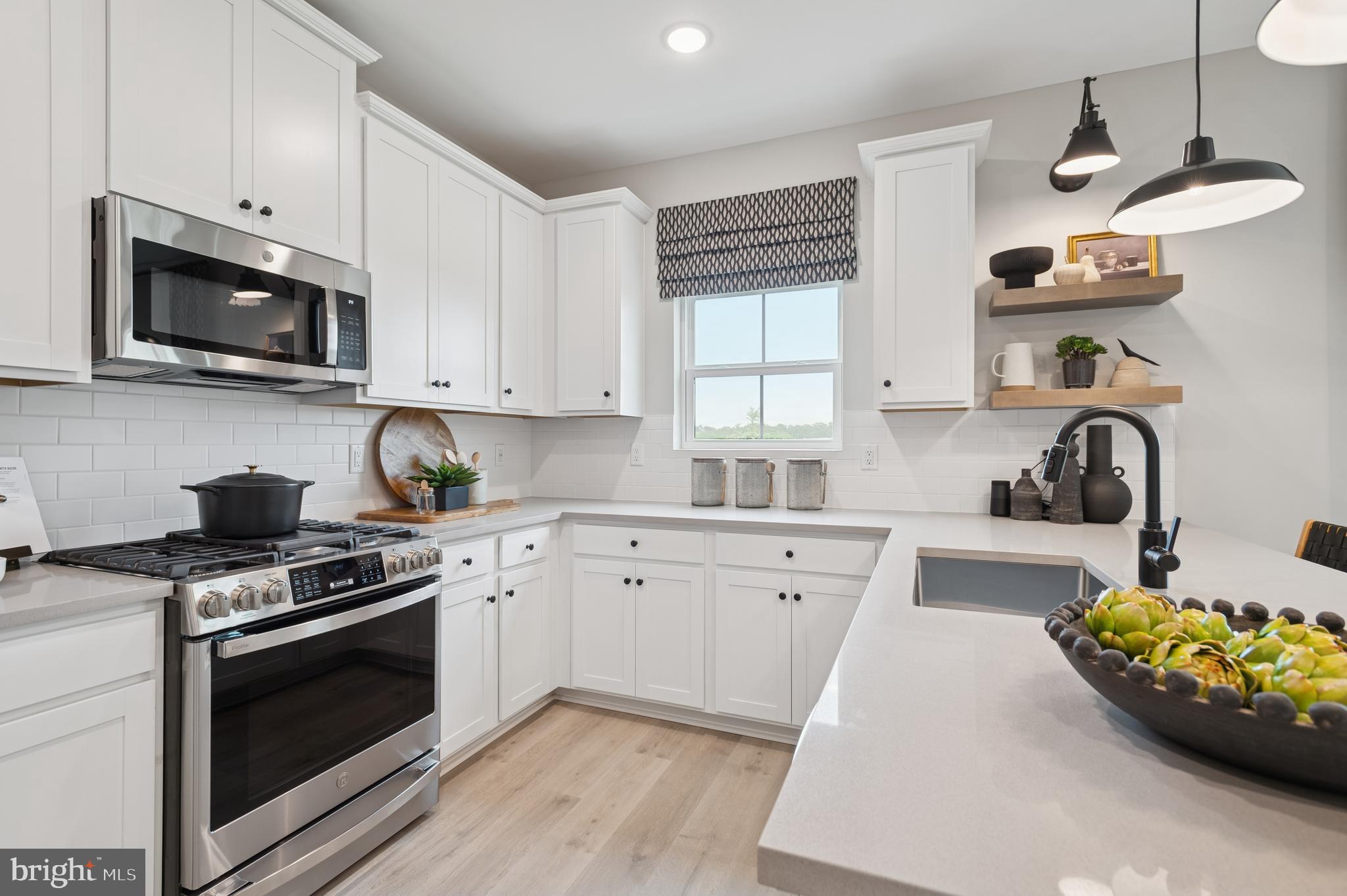 23 Butternut Drive, Unit 12 Berlin, NJ 08009 - Photo 8 of 38 a kitchen with stainless steel appliances white cabinets a sink and a stove