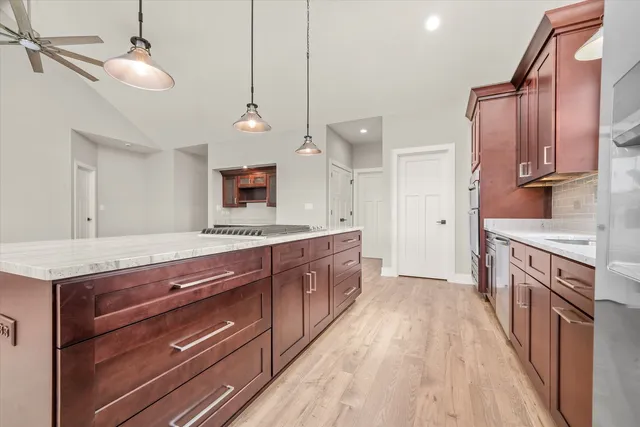 a kitchen with stainless steel appliances granite countertop a sink stove and refrigerator