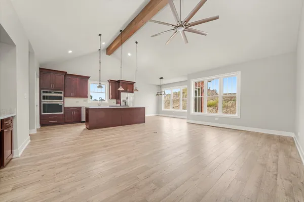 a view of kitchen with furniture and a refrigerator