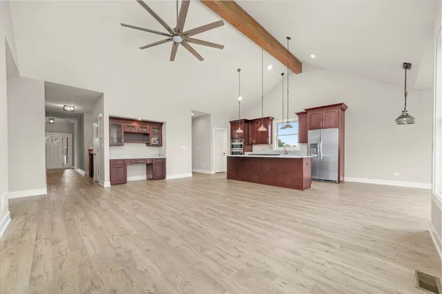 a kitchen with a sink cabinets and wooden floor