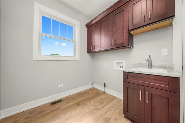 a kitchen with stainless steel appliances kitchen island granite countertop a stove a sink and a microwave oven with cabinets