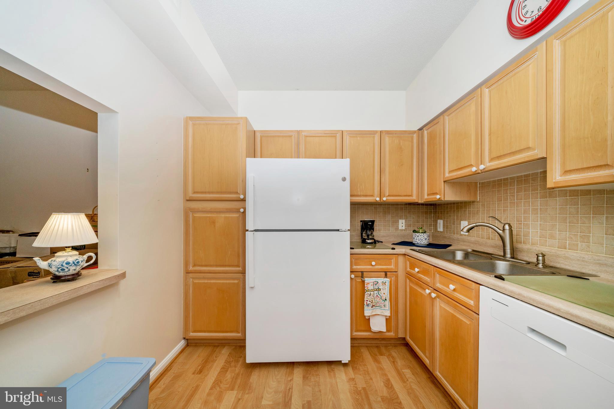 3005 South Leisure World Boulevard, Unit 306 Silver Spring, MD 20906 - Photo 8 of 71 a kitchen with a sink a counter space and cabinets