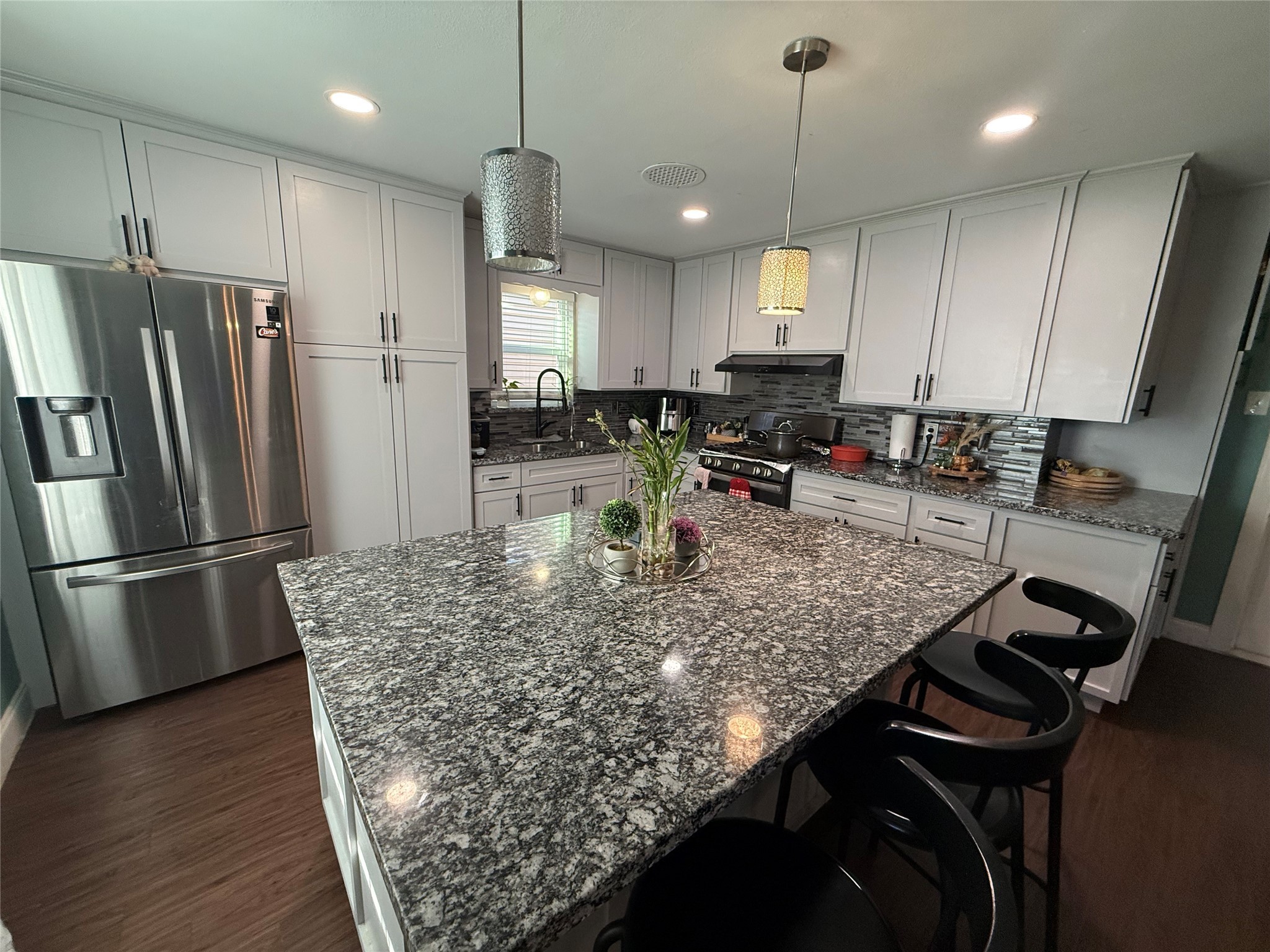 8823 Shadow Crest Street Houston, TX 77074 - Photo 4 of 14 a kitchen with stainless steel appliances granite countertop a sink refrigerator and microwave