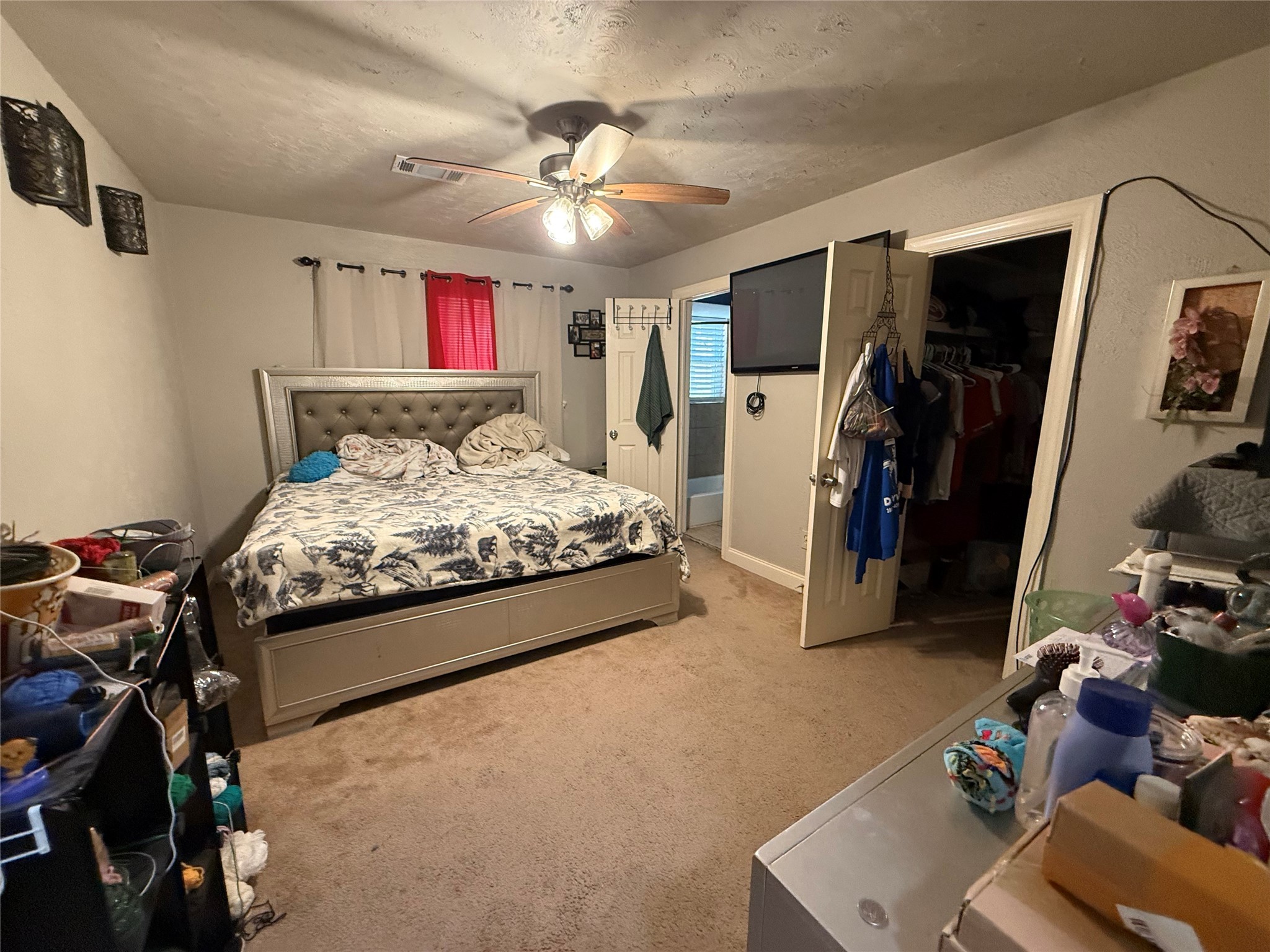 8823 Shadow Crest Street Houston, TX 77074 - Photo 8 of 14 a bedroom with a bed ceiling fan and a dresser