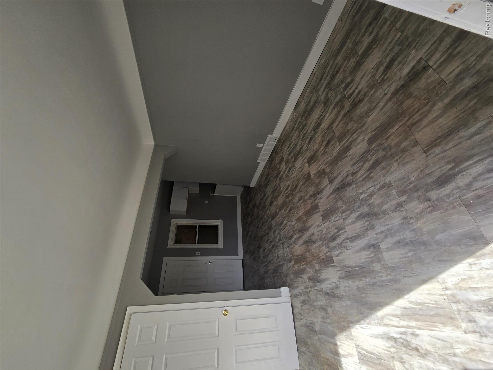 18119 Cornwall Street Detroit, MI 48224 - Photo 3 of 18 Unfurnished living room with baseboards and dark wood-style floors