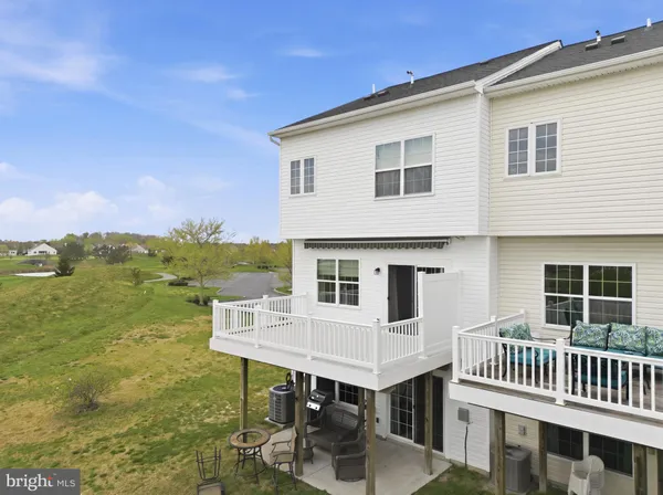an aerial view of a house with outdoor space and lake view