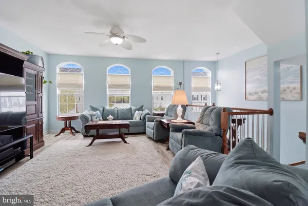 a room with stainless steel appliances kitchen island granite countertop furniture and a refrigerator