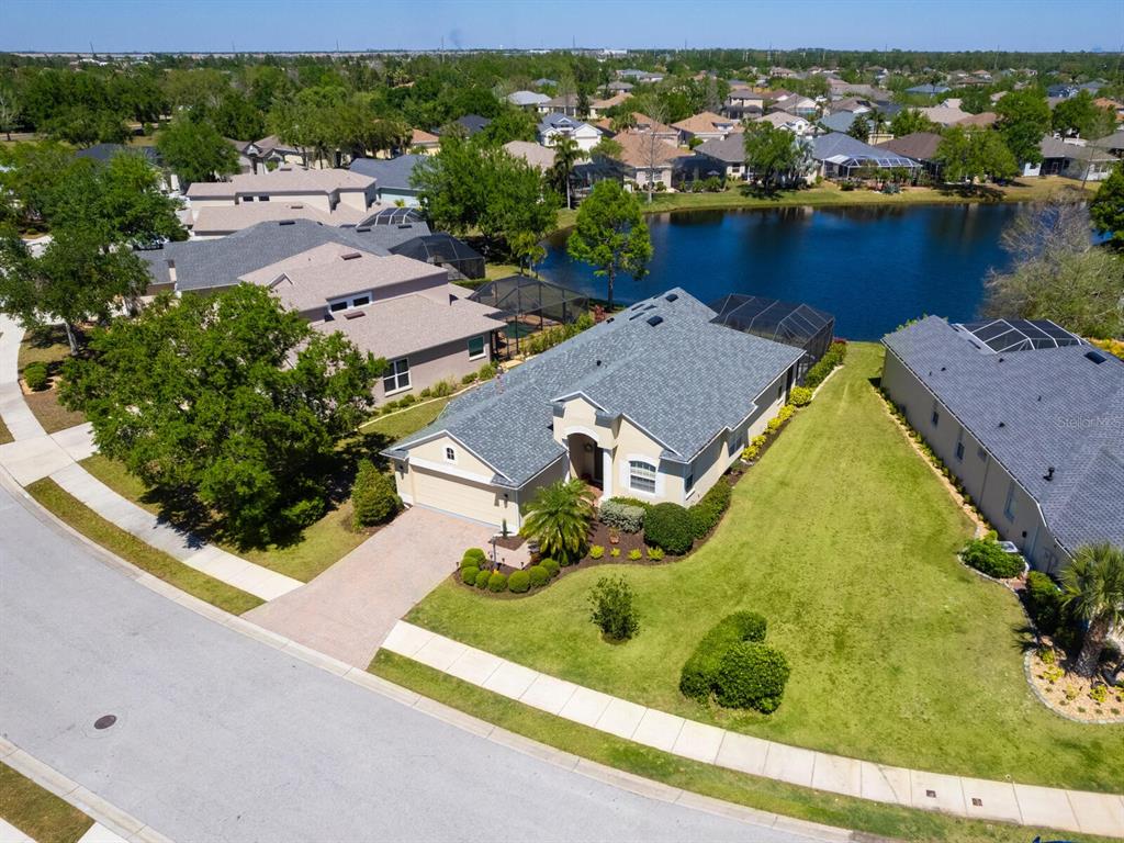 an aerial view of residential houses with outdoor space and river