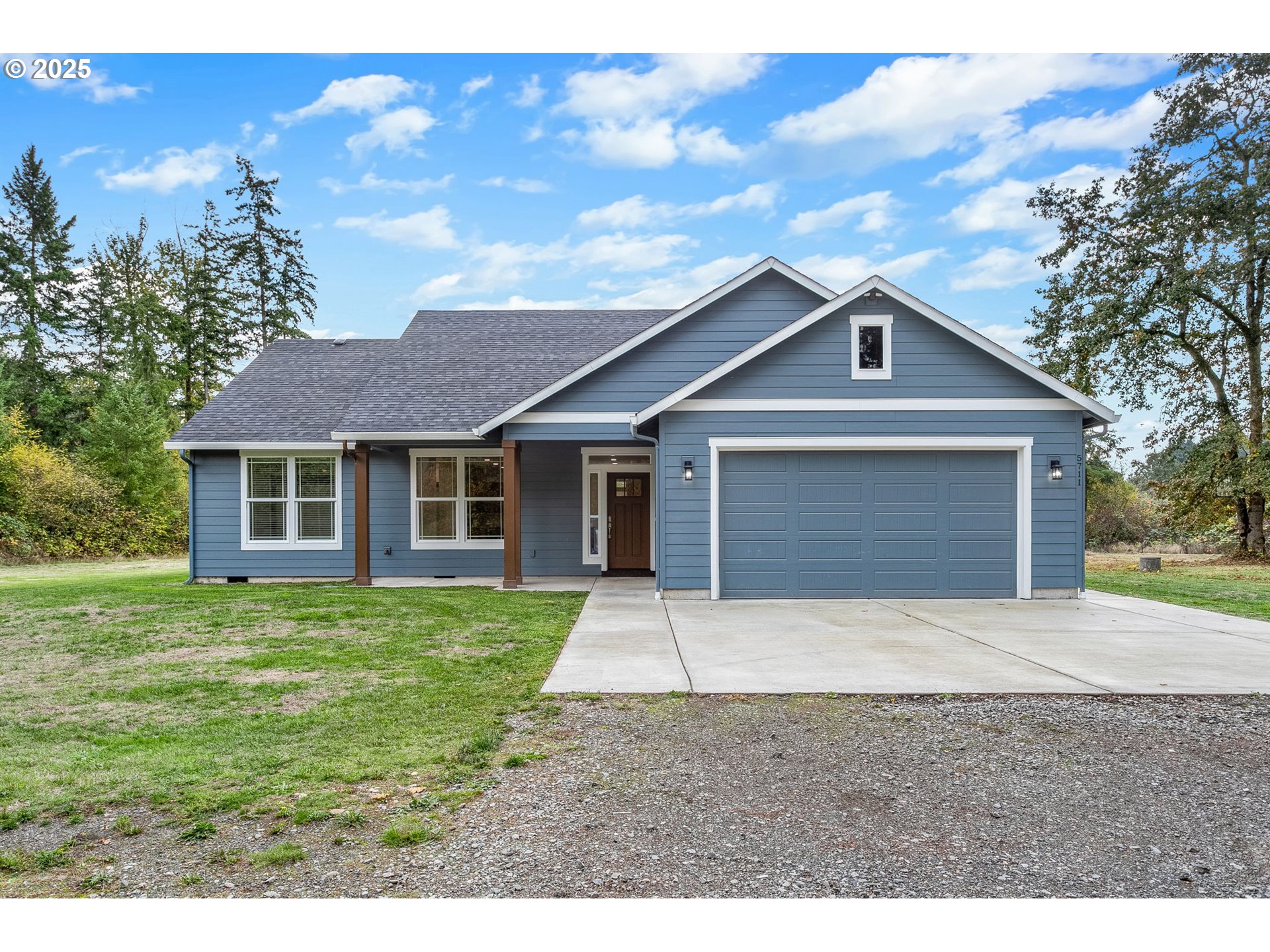 5711 Northeast 246th Street Ridgefield, WA 98642 - Photo 1 of 47 a front view of a house with a garden
