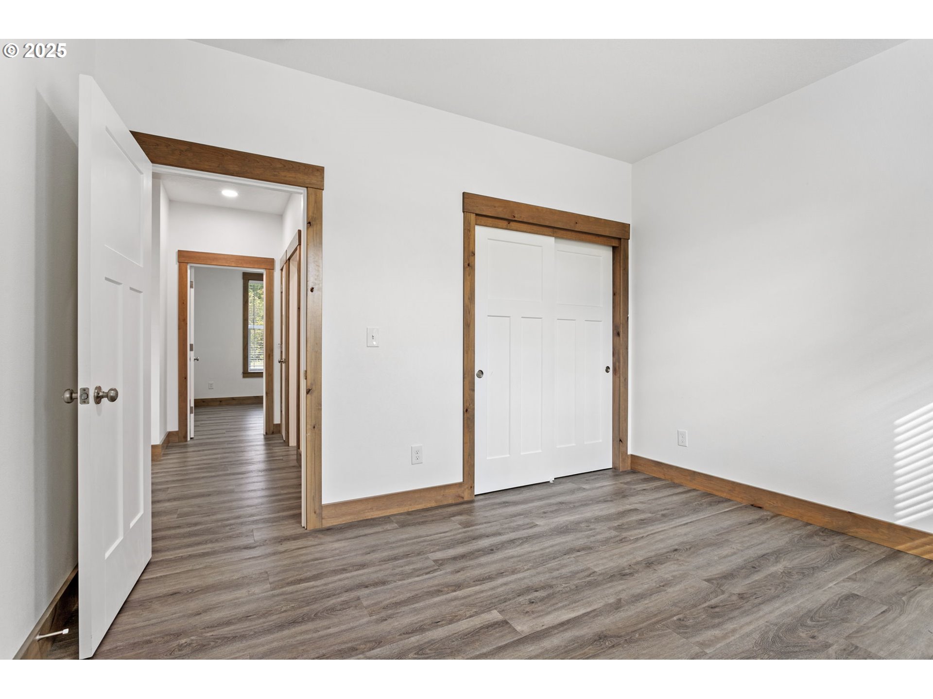 5711 Northeast 246th Street Ridgefield, WA 98642 - Photo 26 of 47 a view of an empty room with wooden floor