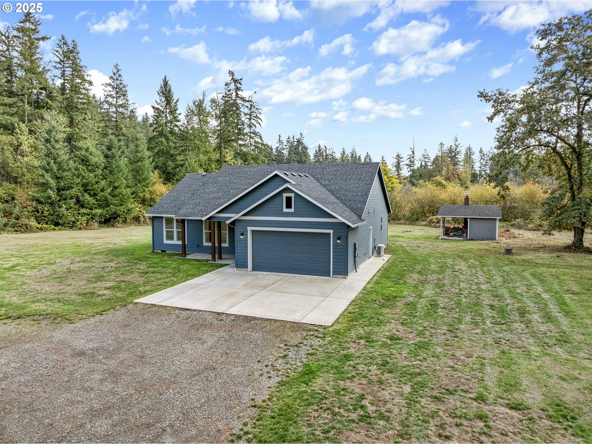 5711 Northeast 246th Street Ridgefield, WA 98642 - Photo 3 of 47 a front view of a house with a yard and garage
