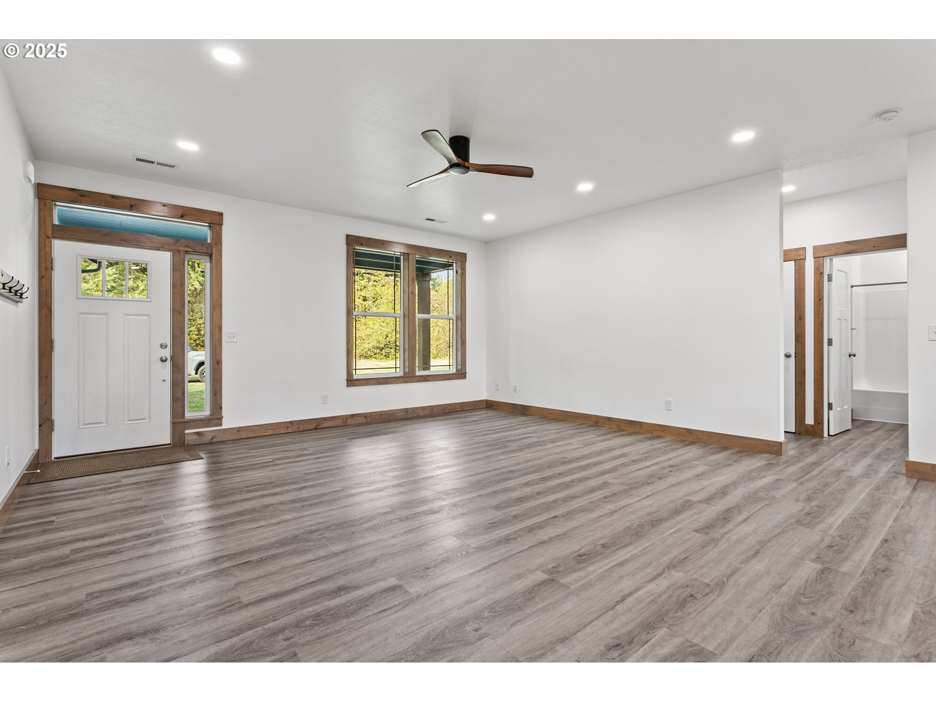 5711 Northeast 246th Street Ridgefield, WA 98642 - Photo 4 of 47 an empty room with wooden floor and windows