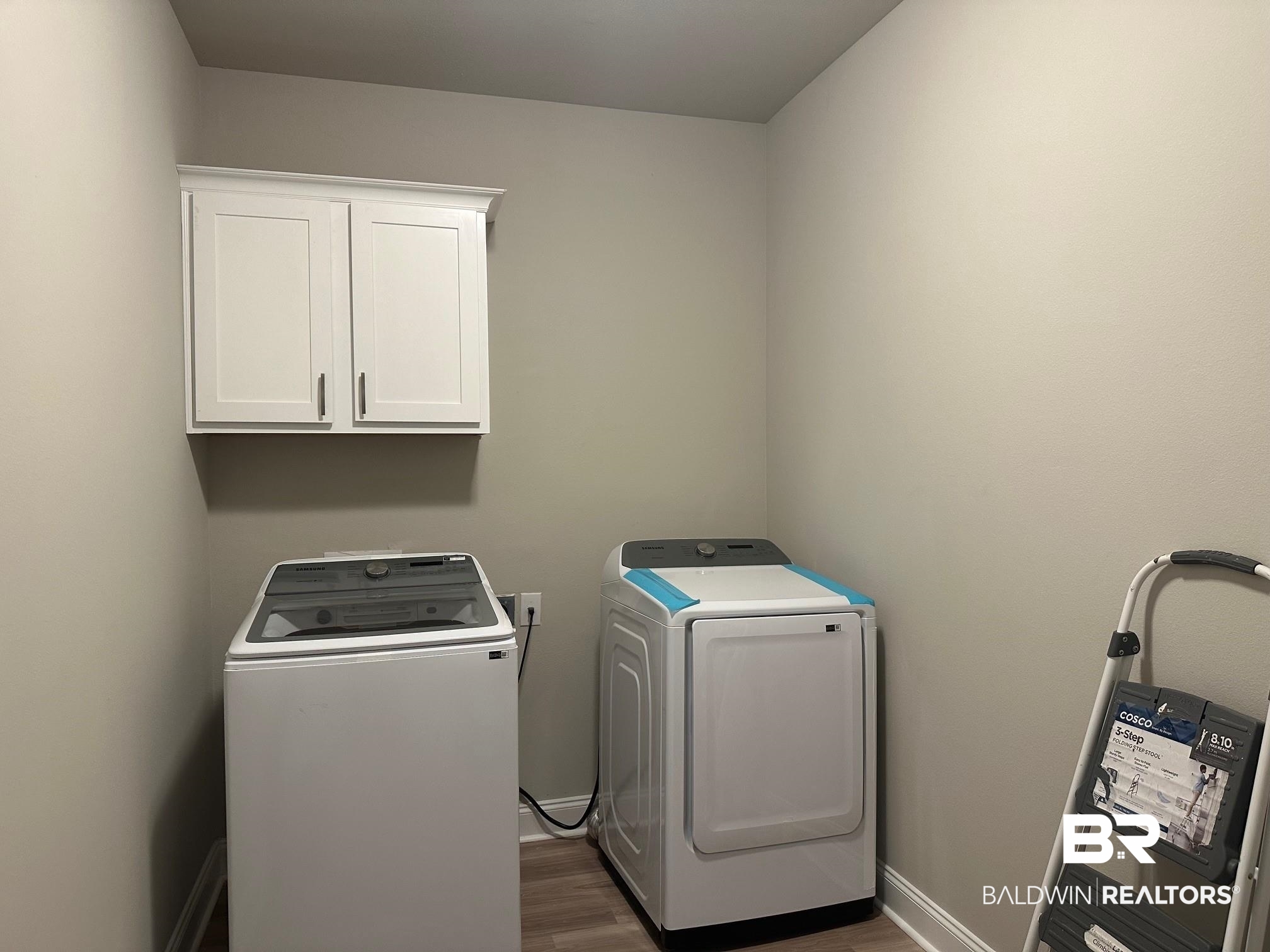 1009 Ruisseau Drive Foley, AL 36535 - Photo 53 of 55 Laundry area featuring cabinets, washer and dryer, and dark hardwood / wood-style flooring