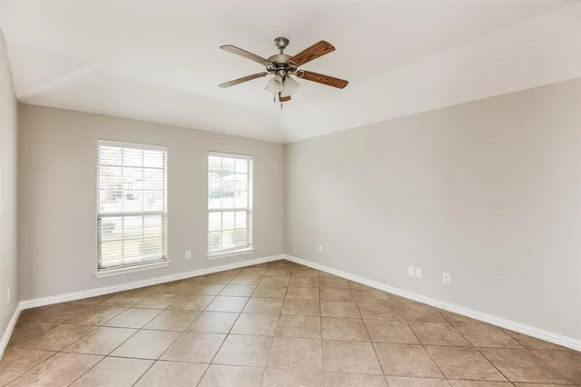 a view of a livingroom with wooden floor and a ceiling fan