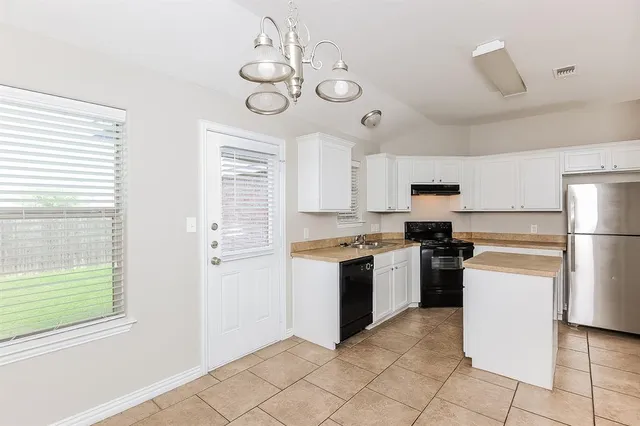 a kitchen with a refrigerator stove and microwave