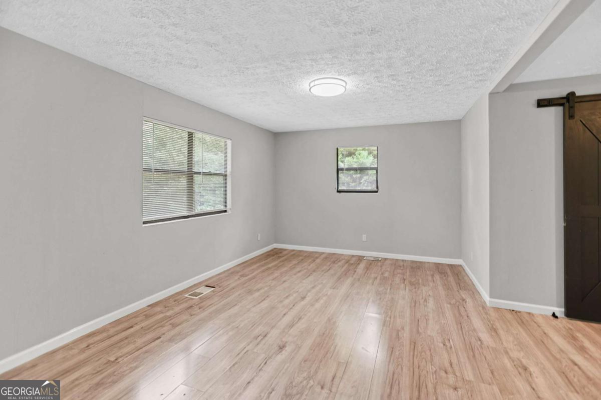 1248 Cannonville Road LaGrange, GA 30240 - Photo 11 of 46 an empty room with wooden floor and windows