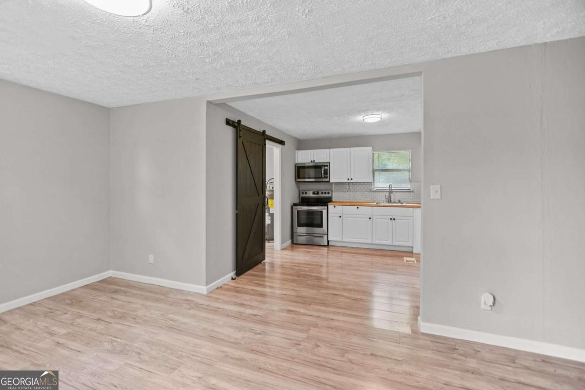 1248 Cannonville Road LaGrange, GA 30240 - Photo 12 of 46 a view of a kitchen with wooden floor electronic appliances and cabinets